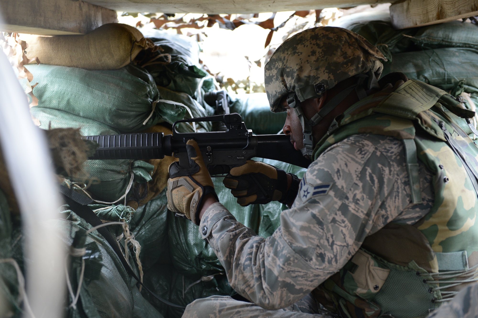 SPANGDAHLEM AIR BASE, Germany – U.S. Air Force Airman 1st Class Corintian Koger, 606th Air Control Squadron theater deployable communications from Tuscumbia, Ala., aims down the sights of his M16 rifle during a combat readiness training (CRT) course April 17, 2013. The CRT helped refresh some of the knowledge the Airmen received in basic training and prepared them for real-world mission taskings. (U.S. Air Force photo by Airman 1st Class Kyle Gese/Released)
