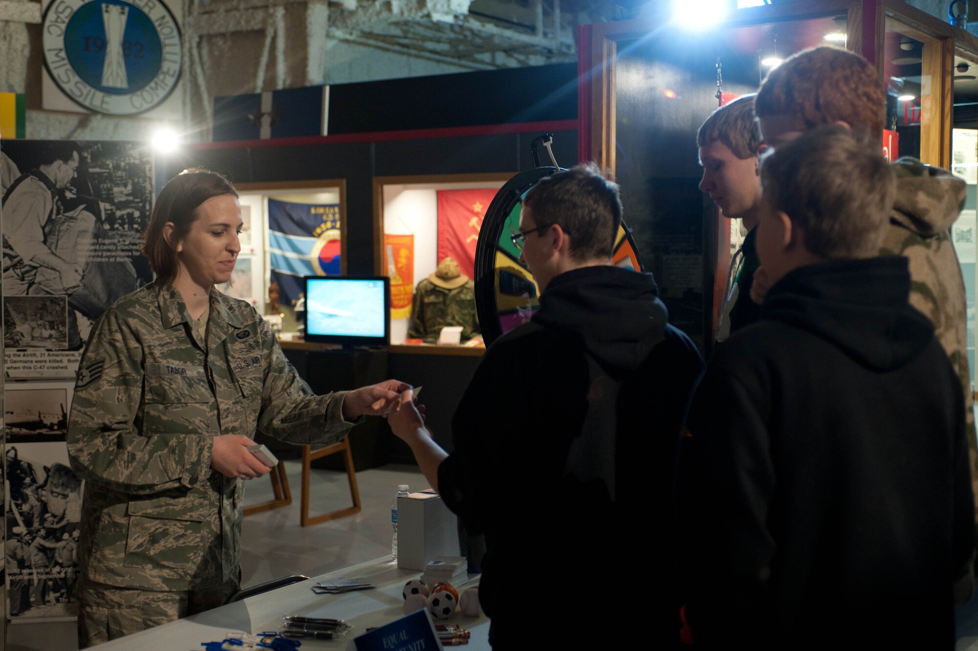 Staff Sgt. Jessica Tabor, 28th Bomb Wing Equal Opportunity office advisor, passes out Ellsworth memorabilia to students from Pierre Middle School at the South Dakota Air and Space Museum in Box Elder, S.D., April 23, 2013 during a career day field trip. Airmen of various ranks and career fields volunteered to share their knowledge of the military, Ellsworth’s mission, their backgrounds, experiences and jobs with the students. (U.S. Air Force photo by Airman 1st Class Zachary Hada/Released)