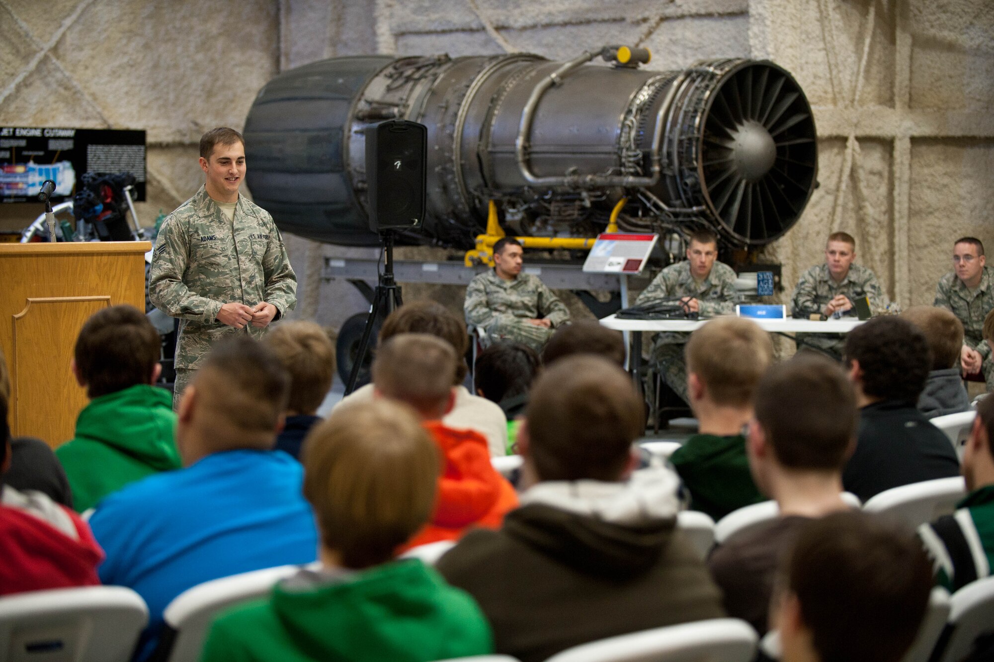 Senior Airman Joseph Adams, 28th Logistics Readiness Squadron vehicle maintenance operator, speaks to students from Pierre Middle School at the South Dakota Air and Space Museum in Box Elder, S.D., April 23, 2013 during a career day field trip. During the trip, students learned about day-to-day life in the military, many of the different career fields in the Air Force, and the importance of good grades and graduating from high school to help them reach their future goals. (U.S. Air Force photo by Airman 1st Class Zachary Hada/Released)