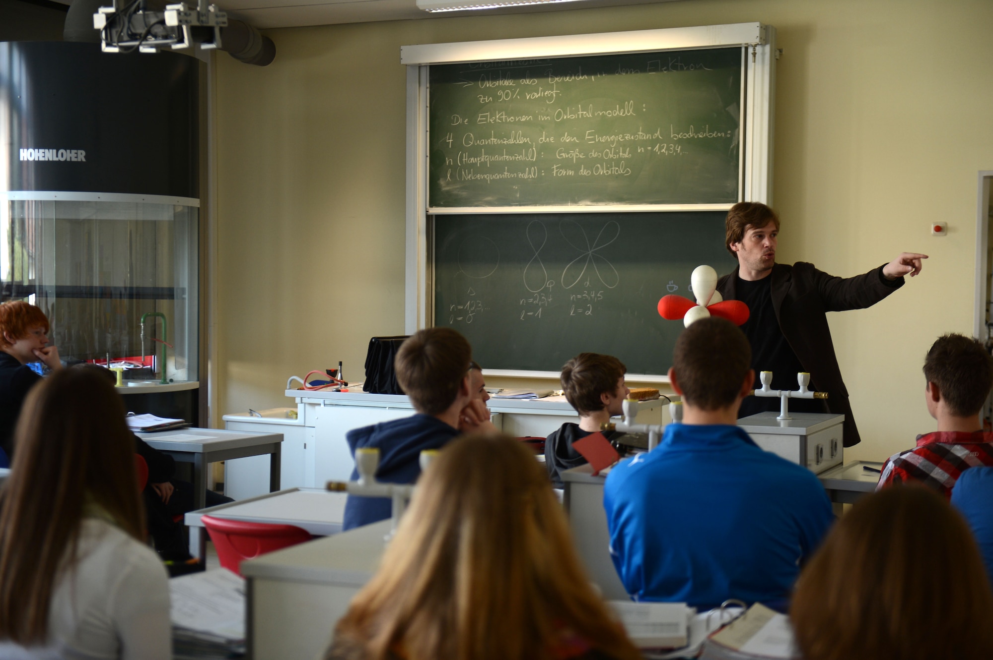 BITBURG, Germany – Sven Mehlhorn, St.-Willibrord-Gymnasium Biology and Chemistry teacher, instructs both American and German students participating in a school exchange program April 22, 2013. American students attended German classes to interact and learn in the foreign environment. (U.S. Air For photo by Airman 1st Class Gustavo Castillo/Released)