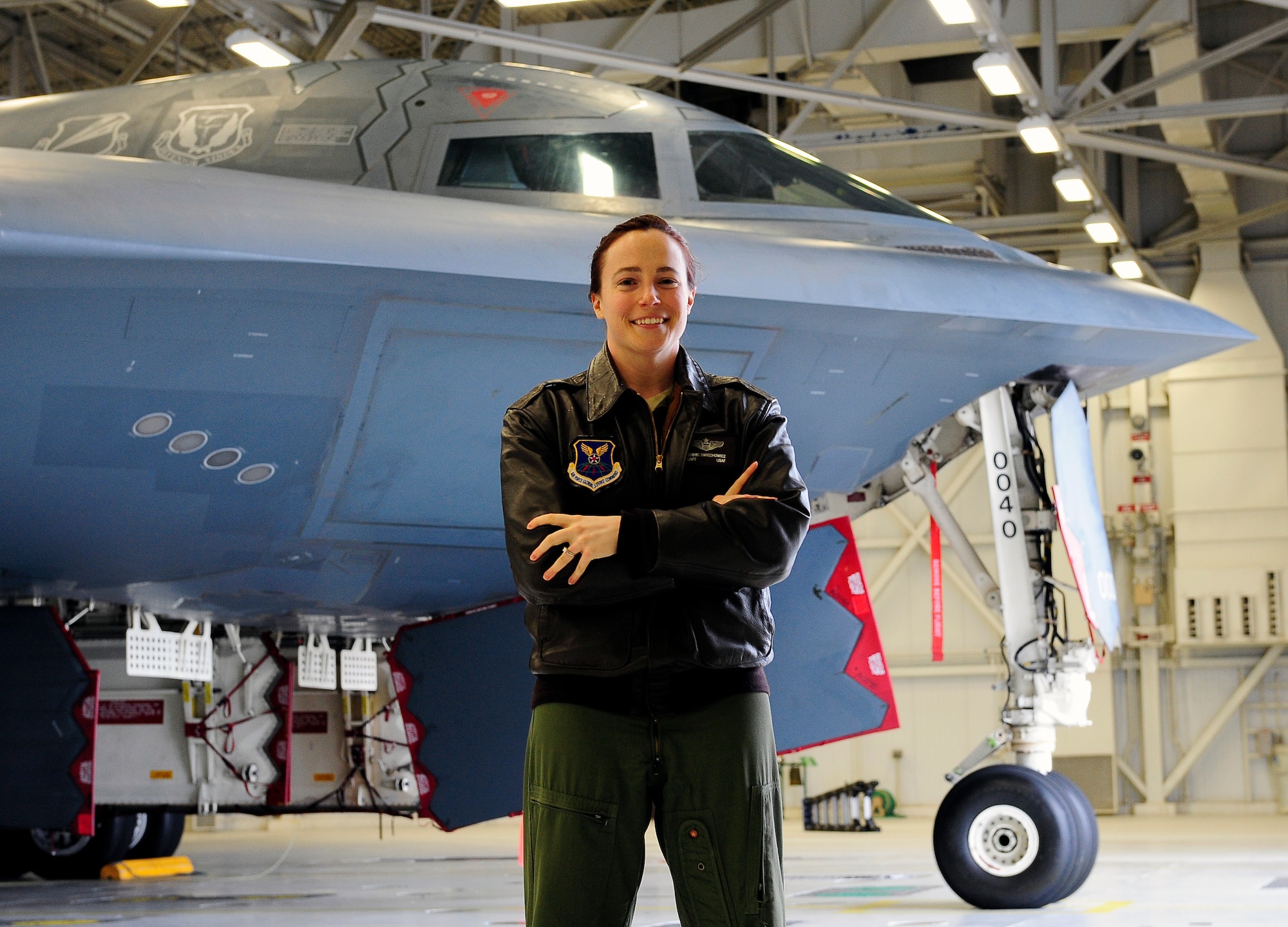 Capt. Jennie Sweichowicz, 393rd Bomb Squadron B-2 Spirit pilot, poses next to a B-2 at Whiteman Air Force Base, Mo., April 23, 2013. Sweichowicz has been a pilot for 10 years. (U.S, Air Force photo by Airman 1st Class Shelby R. Orozco/Released)
