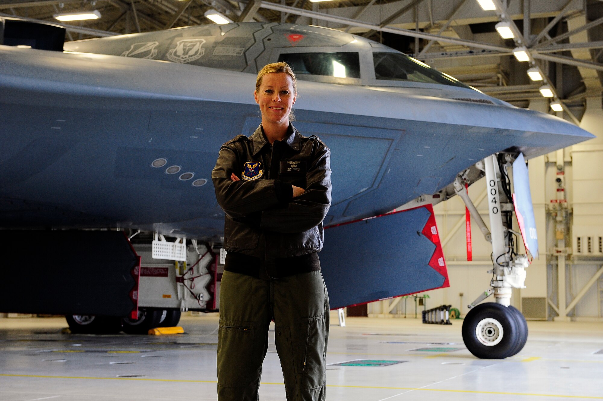 Capt. Nicola Polidor, 393rd Bomb Squadron B-2 Spirit pilot, poses next to a B-2 at Whiteman Air Force Base, Mo., April 23, 2013. Polidor has been flying for eight years and is the 393rd BS training flight commander. (U.S, Air Force photo by Airman 1st Class Shelby R. Orozco/Released)
