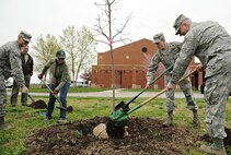 Col. John Price, 375th Air Mobility Wing vice commander, Lt. Col. John Schuliger, 375th Civil Engineer Squadron commander, Second Lt. Drew Gallucci, 375th Civil Engineer Squadron and Mrs. Cindy Nolan, 375th Civil Engineer Squadron environmental manager, plant a swamp white oak tree outside of the Youth Center April 26 at Scott Air Force Base, Ill. Scott AFB has been the recipient of the Tree City USA Award for the past 20 years and is looking to receive another award this year. (U.S. Air Force photo/Airman Kristina Forst)