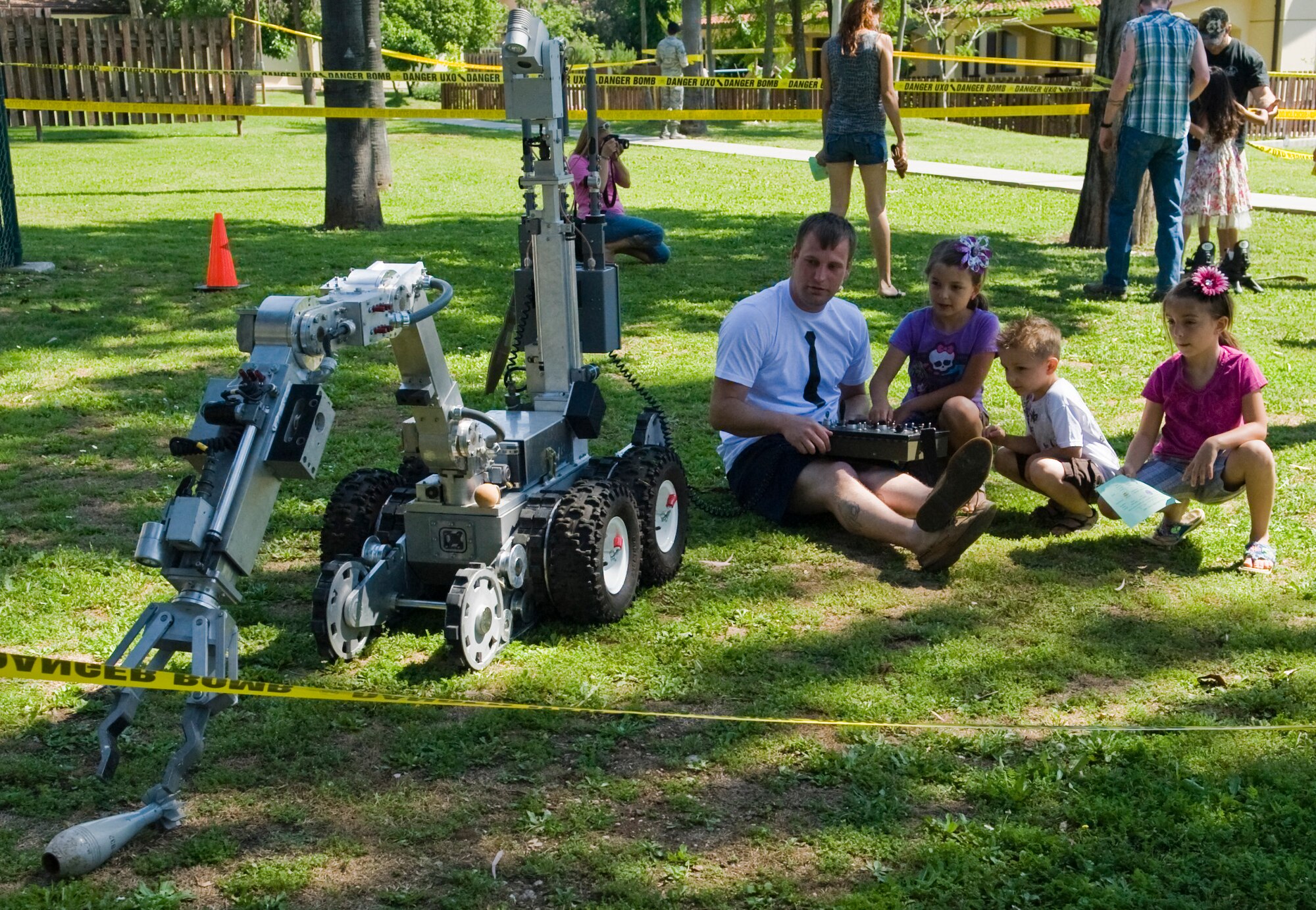 The 39th Civil Engineer Squadron explosive ordnance disposal unit has military kids try out one of their bomb-moving robots April 27, 2013, at Incirlik Air Base, Turkey. The grand finale event Spring-A-Palooza is to celebrate the Month of the Military Child. (U.S. Air Force photo by Staff Sgt. Veuril McDavid/Released)