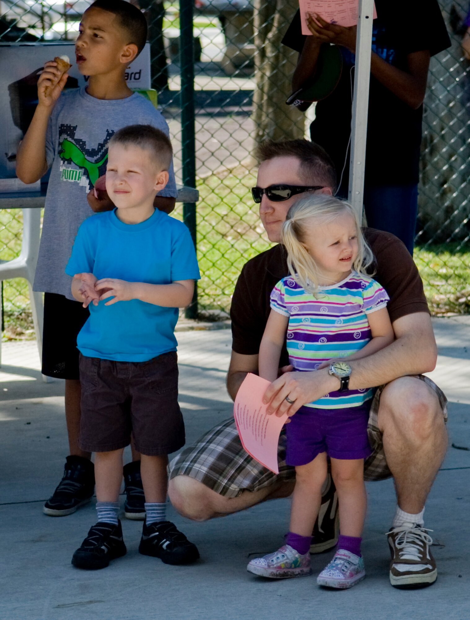 A family listens to introductions at the Spring-A-Palooza event April 27, 2013, at Incirlik Air Base, Turkey. Spring-A-Palooza is an event to celebrate the Month of the Military Child. (U.S. Air Force photo by Staff Sgt. Veuril McDavid/Released)