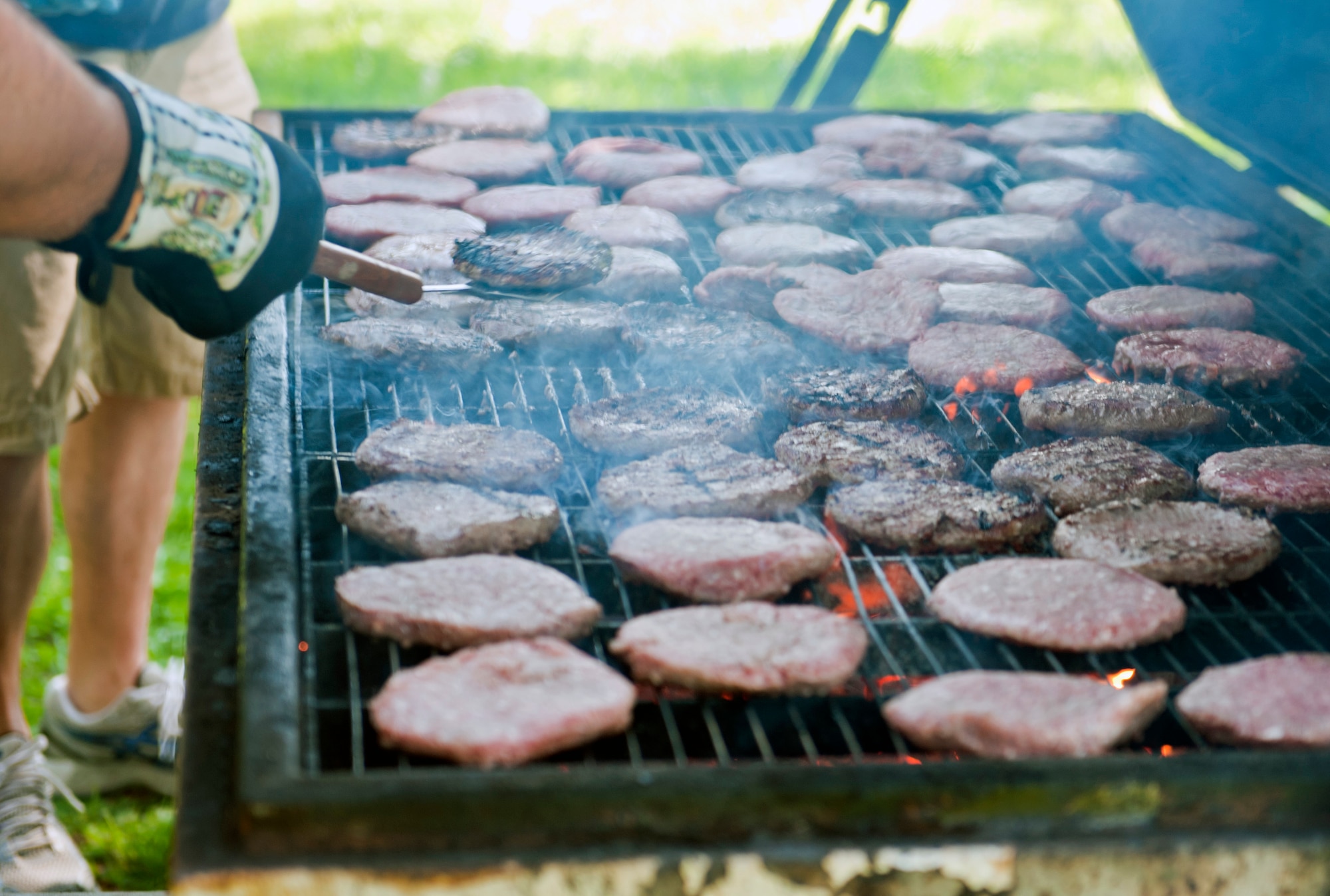 Burger patties are cooked on a grill for Airmen cleaning the dorms by Incirlik first sergeants during the second annual Dorm Spring Cleaning April 26, 2013, at Incirlik Air Base, Turkey. After the Airmen spent all morning cleaning the dorms, they were treated to a barbeque by the first sergeants. (U.S. Air Force photo be Senior Airman Daniel Phelps/Released)