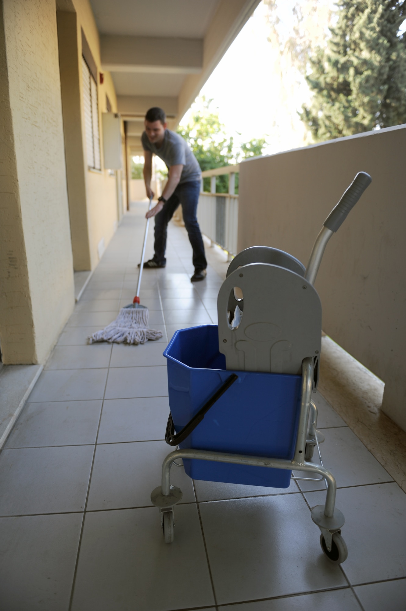 Airman 1st Class Nicholas Crisp, Armed Forces Network-Incirlik broadcaster, cleans outside of the dorms as part of the second annual Dorm Spring Cleaning April 26, 2013, at Incirlik Air Base, Turkey. The dorm cleaning was created as a way to show pride and encourage a sense of community for Airman’s living areas. (U.S. Air Force photo by Senior Airman Daniel Phelps/Released)