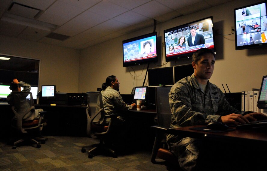 Airmen from Homestead Air Reserve Base, Fla., conduct operations on the new console inside the completely upgraded Command Post April 19. Among the many improvements, the base Command Post received a new state-of-the-art console and Installation Command Center as well as an expanded amount of space to conduct its operations. (U.S. Air Force photo/Ross Tweten)