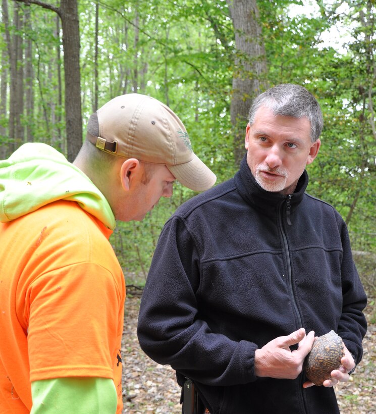 U.S. Army Maj. Matthew Buck, 597th Transportation Brigade training and readiness officer, learns about eastern box turtles from James Dolan, 733rd Civil Engineer Division environmental element wildlife biologist, during the third annual Box Turtle Survey in Training Areas 1 and 2 at Fort Eustis, Va., April 23, 2013. The survey was part of the installation’s Earth Week celebration April 22-26. Box turtles can live for 30 to 40 years in the wild; they are territorial and have a small home range, making it important not to remove them from their environment. (U.S. Air Force photo by Tech. Sgt. April Wickes/Released)
