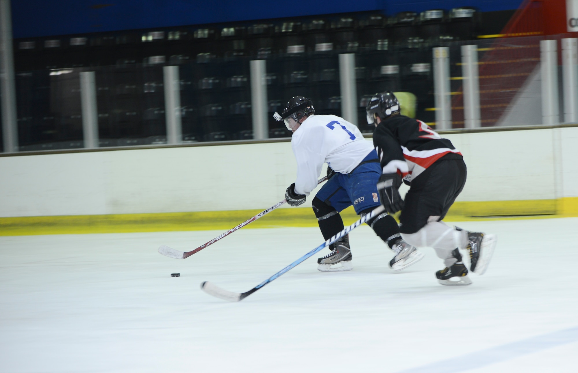 PETERBOROUGH, England - Airman 1st Class Brendan McCormick (left), U.K. Warbirds player and member of the 48th Equipment Maintenance Squadron, makes a fast break during a practice session March 29, 2013. The U.K. Warbirds is the U.S. Air Force hockey team in the U.K. McCormick hails from White Lake, Mich. (U.S. Air Force photo by Staff Sgt. Stephen Linch)