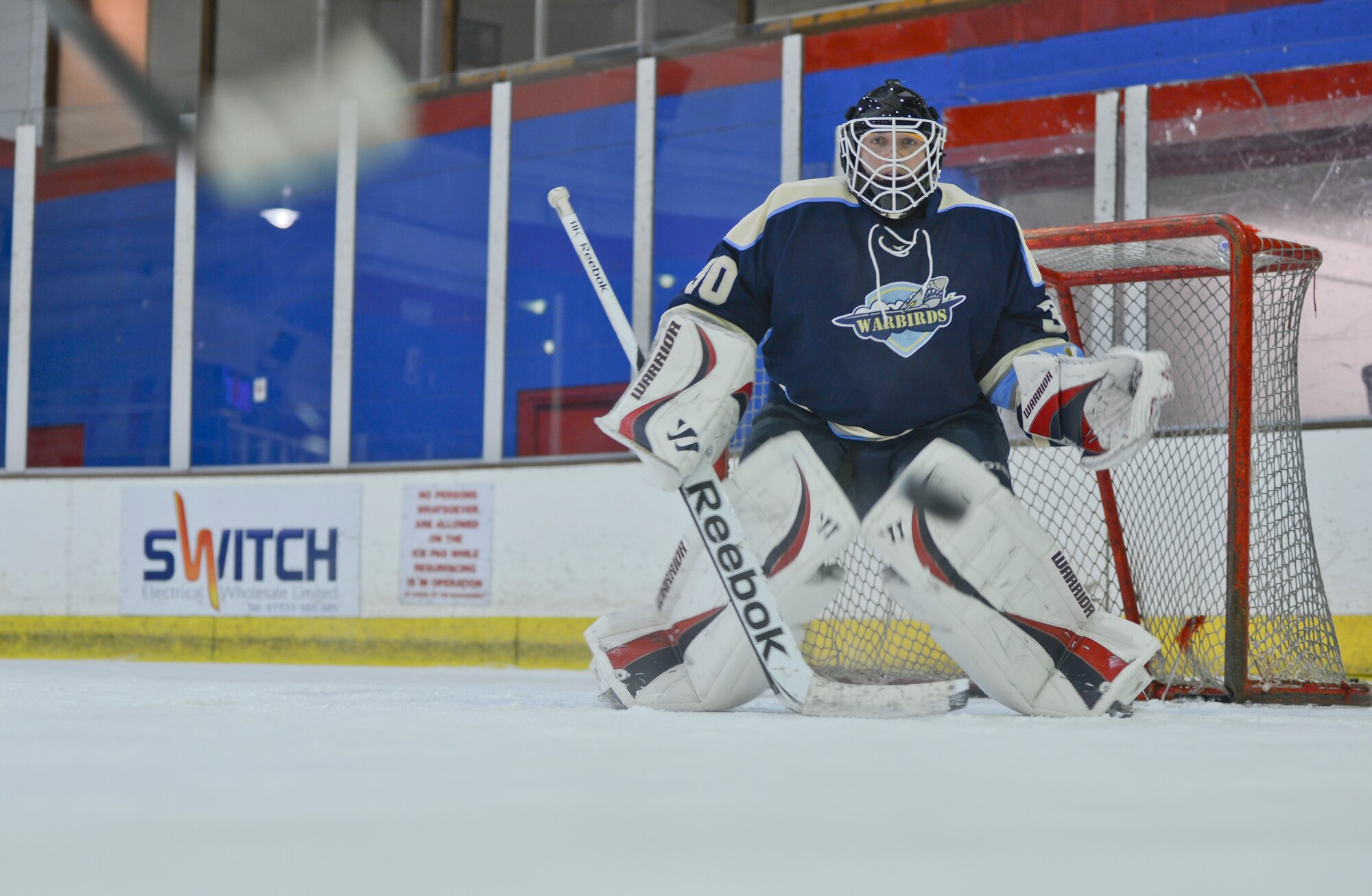 PETERBOROUGH, England - Master Sgt. Steven Kellerman, U.K. Warbirds goalie and member of the 48th Operations Support Squadron, moves to block a shot during a practice session March 29, 2013. The U.K. Warbirds is the U.S. Air Force hockey team in the U.K. Kellerman hails from Buffalo, N.Y. (U.S. Air Force photo by Staff Sgt. Stephen Linch)