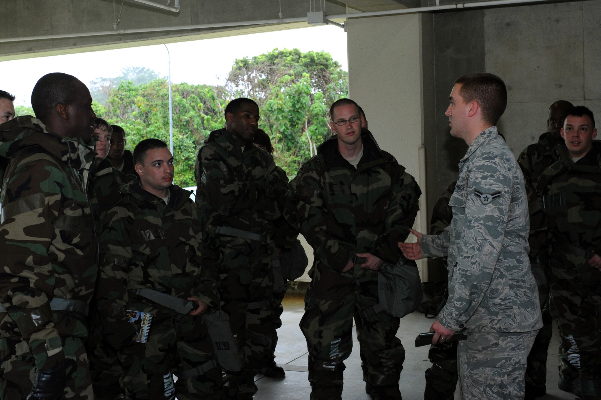 U.S. Air Force Airman 1st Class Zachary Duke, 18th Civil Engineer Squadron emergency manager, briefs 18th Mission Support Group personnel during an Ability to Survive and Operate Rodeo on Kadena Air Base, Japan, April 25, 2013. The ATSO Rodeo was a training exercise event where Kadena's Airmen tested their skills and techniques used to survive in a chemical wartime environment. (U.S. Air Force photo by Airman 1st Class Hailey R. Davis/Released)