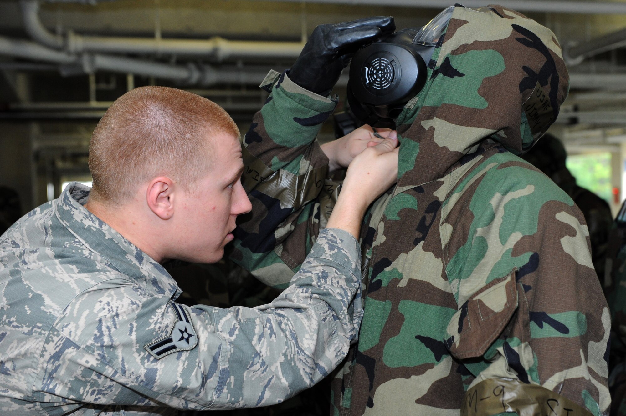 U.S. Air Force Airman 1st Class Mckenzie Williams, 18th Civil Engineer Squadron emergency management apprentice, checks a member of the 18th Mission Support Group during an Ability to Survive and Operate Rodeo on Kadena Air Base, Japan, April 25, 2013. The ATSO Rodeo was a training exercise event where Airmen honed the skills necessary to survive in a wartime contingency. (U.S. Air Force photo by Airman 1st Class Hailey R. Davis/Released)