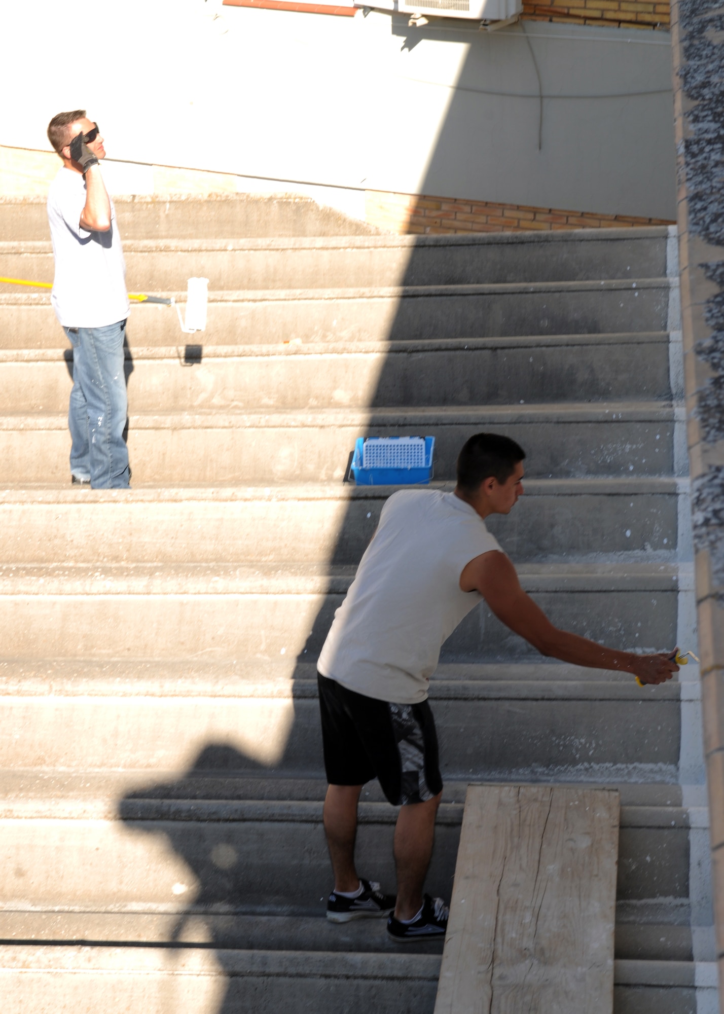 From left, Master Sgt. William Jancouskas and Senior Airman Samuel Dahlgren-Castilla, both from the 100th Air Refueling Wing, volunteer their time to paint a convent for local children April 25, 2013, in Southwest Europe. The Airmen from the 100th took the opportunity to give their time to the local community and provide some necessary maintenance to the convent grounds. (U.S. Air Force photo by 1st Lt. Christopher Mesnard/Released)