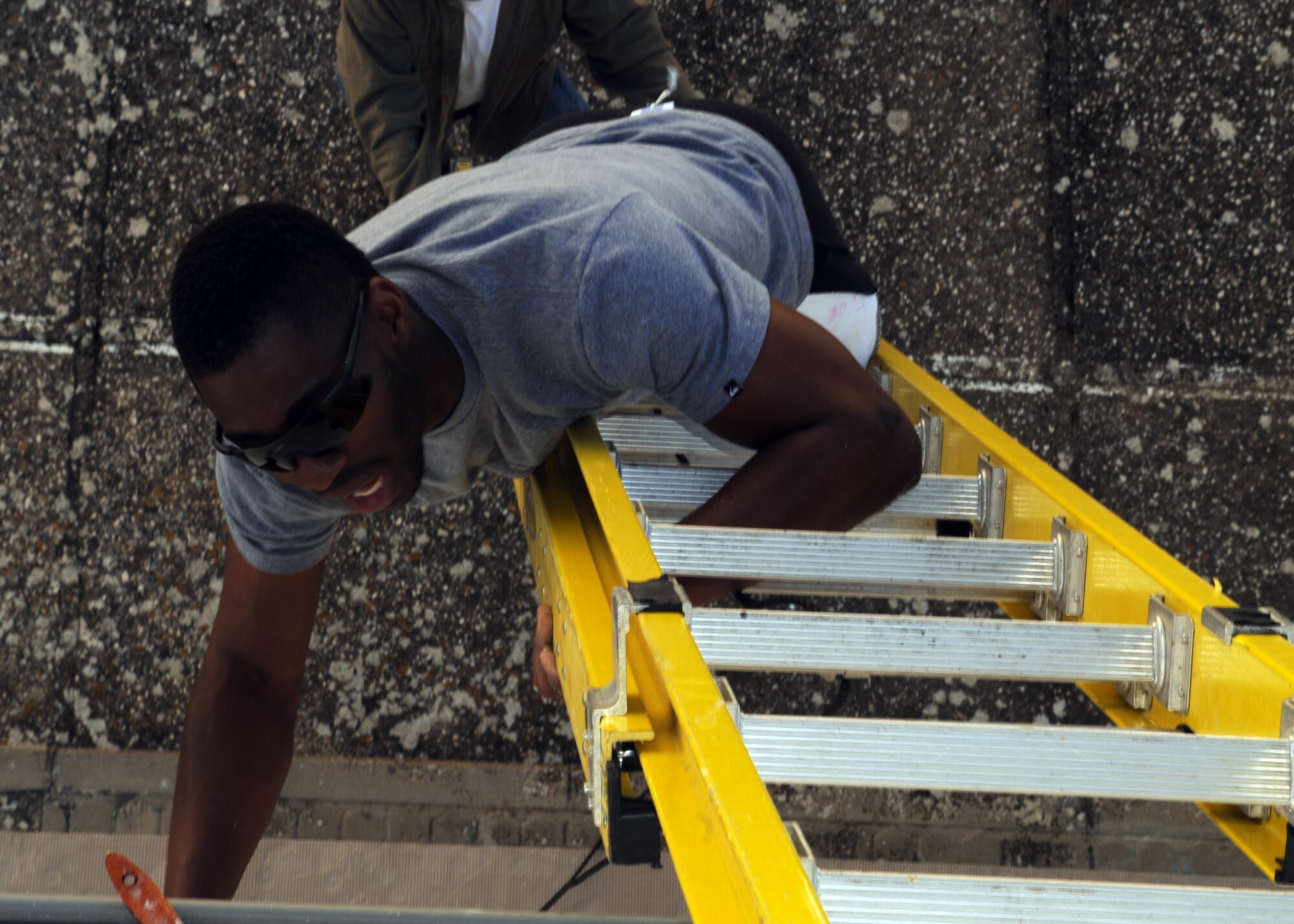 Staff Sgt. Cho Diforchu, 100th Air Refueling Wing, paints a wall on a convent for local children April 25, 2013, in Southwest Europe. The convent provides education and other services to children in the area and needed a new coat of paint to prevent the buildings from deteriorating. (U.S. Air Force photo by 1st Lt. Christopher Mesnard/Released)      130424-F-DT859-046