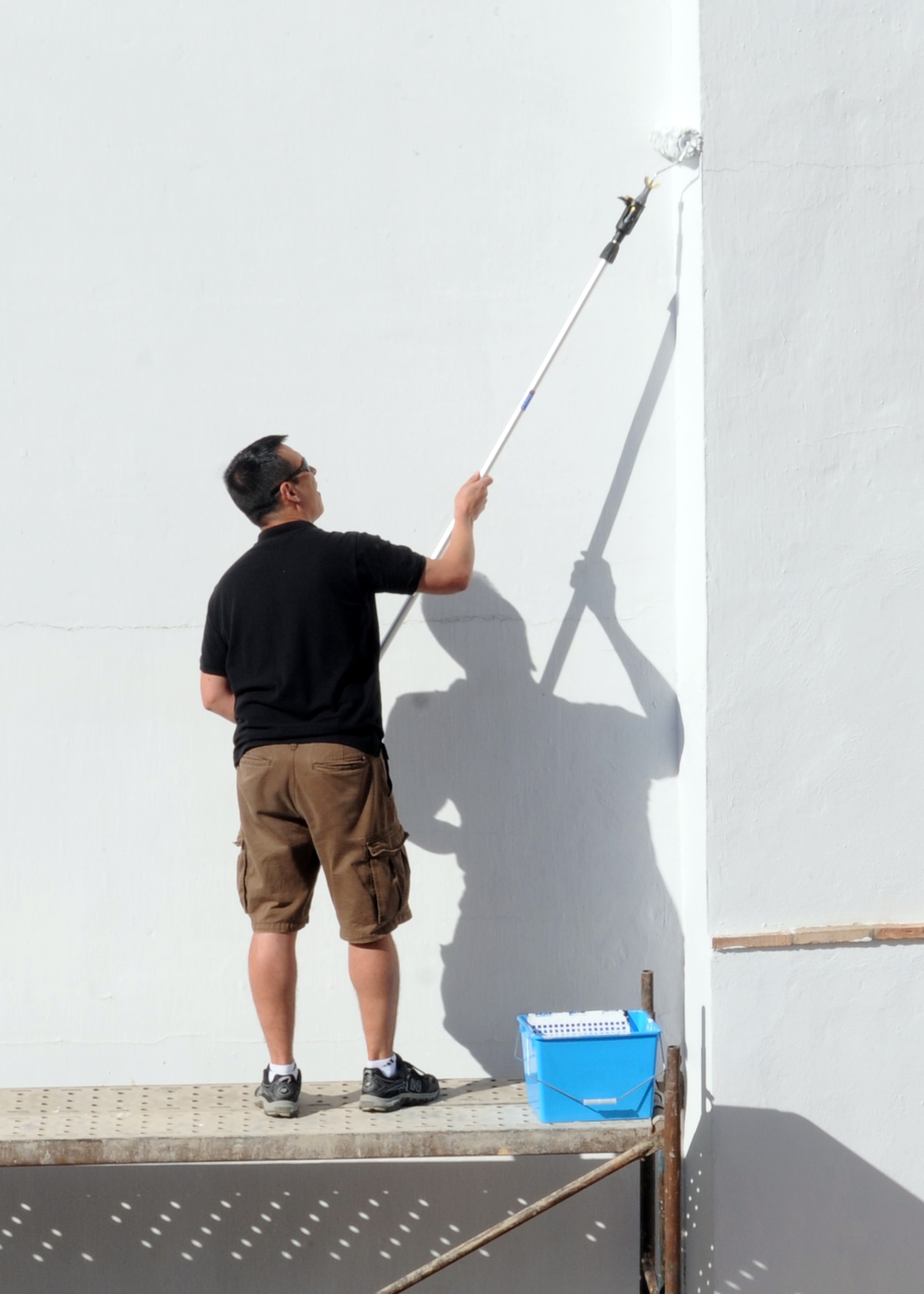 Maj. Glen Priddy, 100th Air Refueling Wing, paints a wall on a convent for local children April 25, 2013, in Southwest Europe. The convent provides education and other services to children in the area and needed a new coat of paint to prevent the buildings from deteriorating. (U.S. Air Force photo by 1st Lt. Christopher Mesnard/Released)