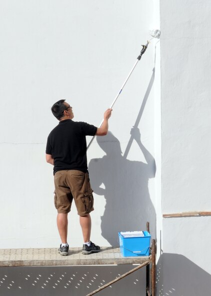 Maj. Glen Priddy, 100th Air Refueling Wing, paints a wall on a convent which provides services to local children April 25, 2013, in Southwest Europe. The convent provides education and other services to children in the area and needed a new coat of paint to prevent the buildings from deteriorating. (U.S. Air Force photo by 1st Lt. Christopher Mesnard/Released)