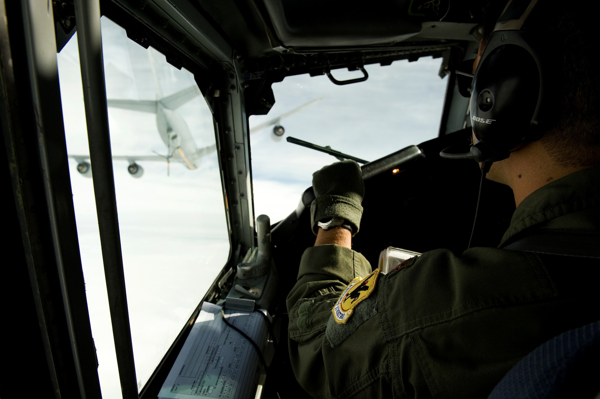 A U.S. Air Force E-3 Sentry pilot from the 961st Airborne Air Control Squadron on Kadena Air Base, Japan, and his copilot fly toward a KC-135 Stratotanker aerial refueling aircraft April 18, 2013. With its command and control capabilities and intelligence, surveillance and reconnaissance mission, the E-3 Sentry Airborne Warning and Control System aircraft assigned to the unit opens the crew's and Kadena's eyes to virtually everything in the air. It's this capability that allows Kadena and other Air Force assets to project superior force for any contingency. (U.S. Air Force photo by Senior Airman Maeson L. Elleman/Released)