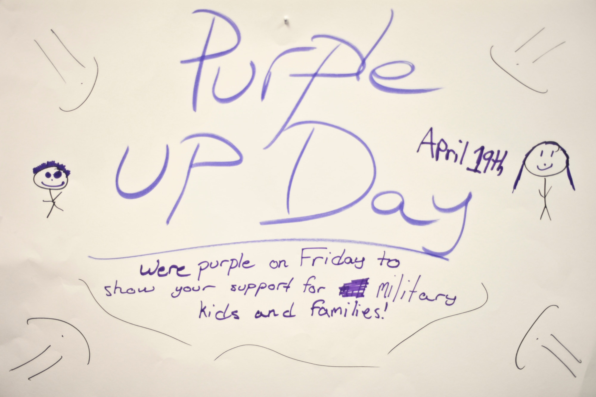 A banner drawn by Robert M. Crawford Elementary students promotes Purple Up Day in the school hallway April 19, 2013, Eielson Air Force Base, Alaska.  Students participated in the event, a national calling to show support for youth in military families, by decorating the school's hallways with signs and balloons.  (U.S. Air Force Photo by Airman 1st Class Peter Reft/Released)