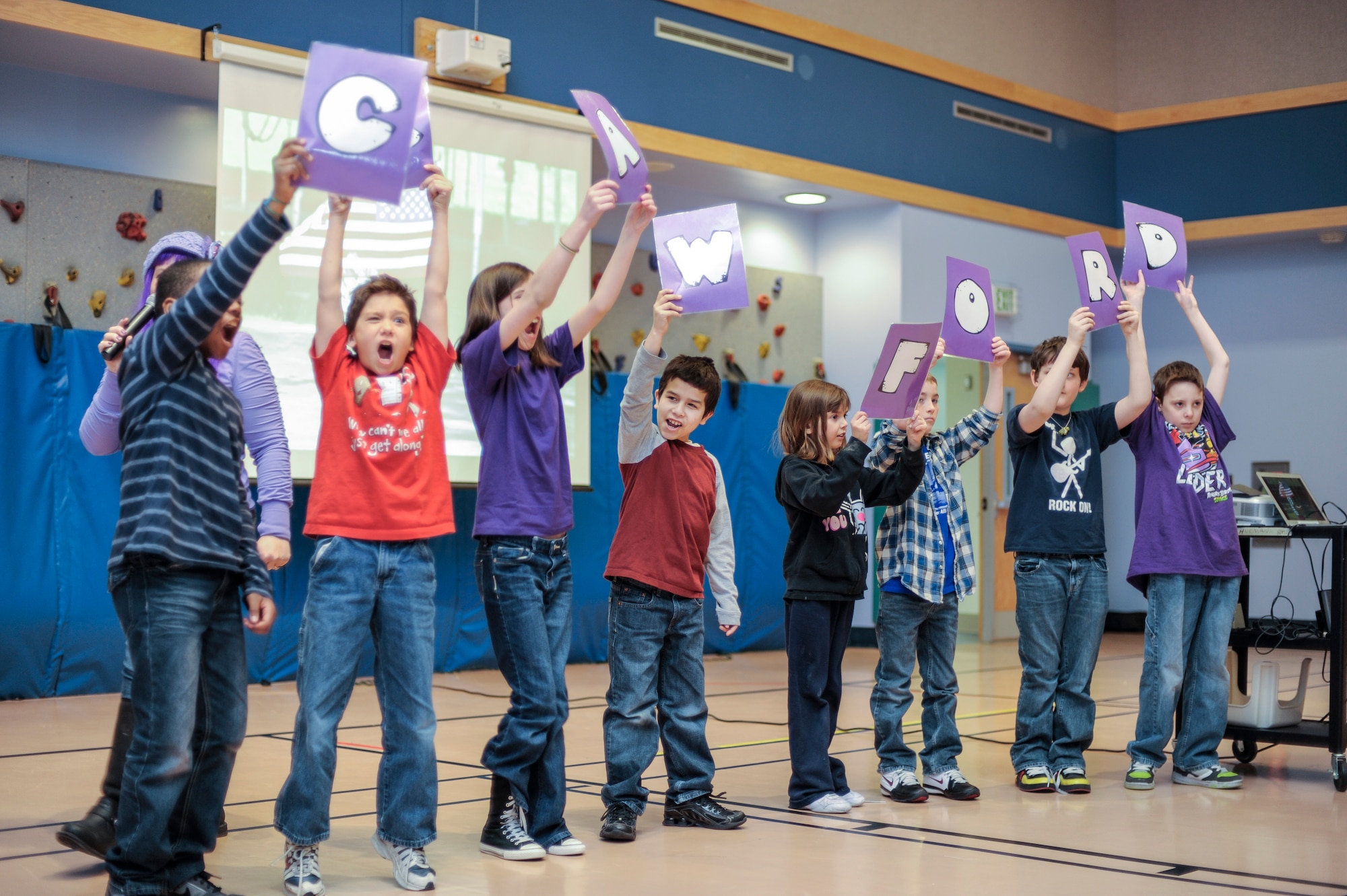 Robert M. Crawford Elementary students perform a Crawford cheer in the school gym during Purple Up Day, April 19, 2013, Eielson Air Force Base, Alaska.  The students assembled in the gymnasium to demonstrate their military pride by wearing purple, singing patriotic songs and cheering for their school.  (U.S. Air Force Photo by Airman 1st Class Peter Reft/Released)