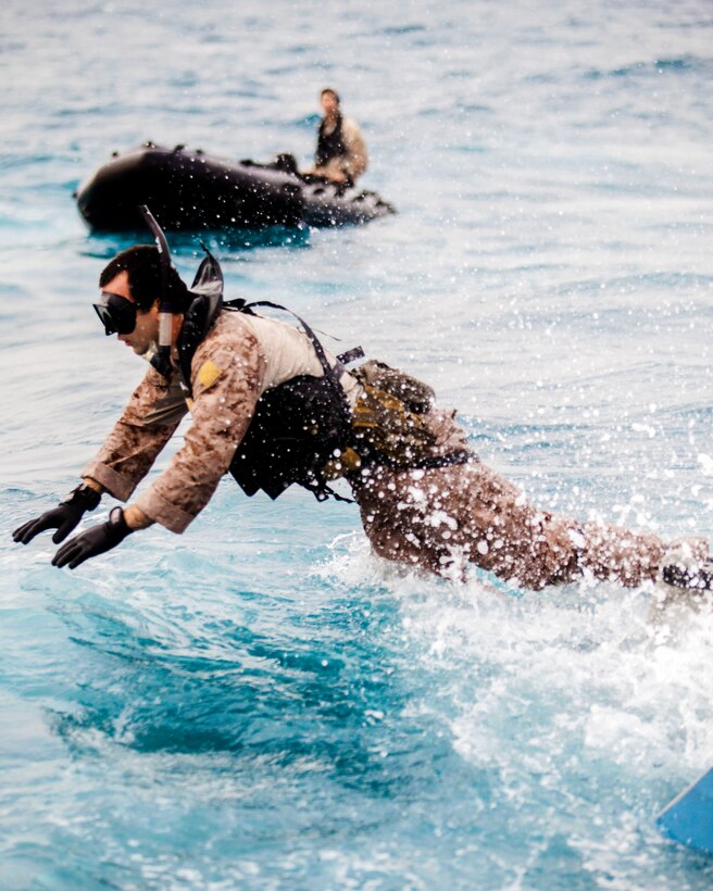 A U.S. Marine participates in scout swimming exercises at sea during ...