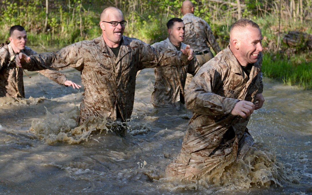 A group of Headquarters Company, Headquarters and Service Battalion Marines run through the swamp like pond called the “smelly gully,” during Headquarters Co.’s physical training event April 24, 2013. The “smelly gully” was arguably the obstacle the Marines enjoyed the most.