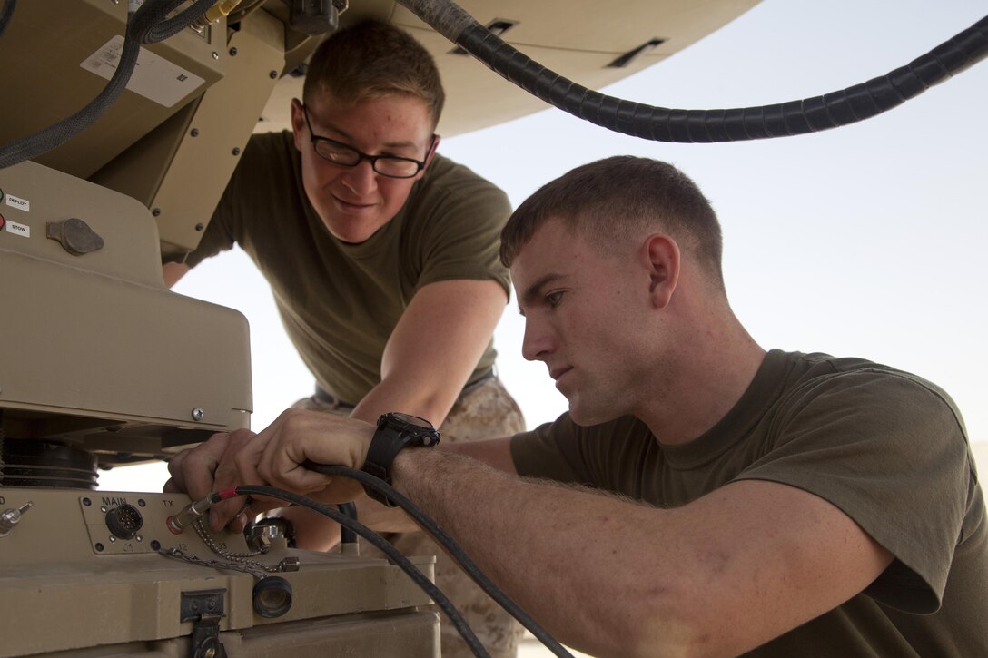 U.S. Marine Corps Lance Cpl. Zachary Schaible, left, and Sgt. Calvin Rogers, from Corona, Calif. and Decatur, Tenn., respectively, both assigned to Headquarters Company, Regimental Combat Team (RCT) 7, set up Secure Internet Protocol and Non-secure Internet Protocol Router Access Point (SNAP) satellite communications system on Camp Leatherneck, Helmand province, Afghanistan, April 24, 2013. The SNAP satellite communication system provides headquarter units such as RCT-7 to remain in constant contact with Marines deployed to distant forward operating bases. (U.S. Marine Corps photo by Cpl. Alejandro Pena/Released) 