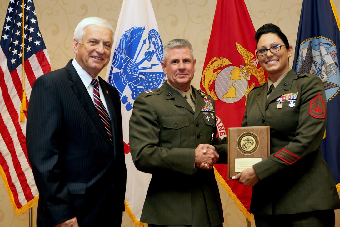 GEICO chairman Tony Nicely, Commanding General of Training and Education Command Maj. Gen. Thomas M. Murray, and the 17th Sergeant Major of the Marine Corps Sgt. Maj. Micheal P. Barrett, present Gunnery Sgt. Tina M. Kelley the 2012 GEICO Military Service Award at the Key Bridge Marriott in Arlington, Va., on April 29, 2013. (U.S. Marine Corps photo by Sgt. Marionne T. Mangrum)