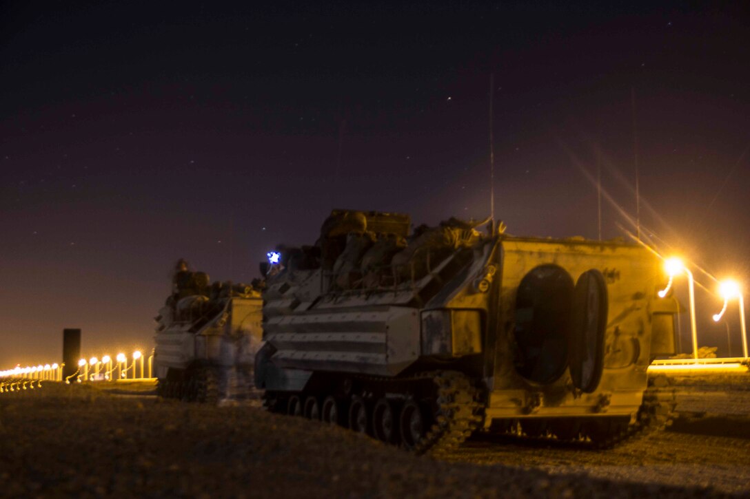 Marines assigned to Amphibious Assault Vehicle (AAV) Platoon, Battalion Landing Team 3/2, 26th Marine Expeditionary Unit (MEU), work in the darkness of night to diagnose a mechanical fault in one of the unit's AAVs during an exercise in the 5th Fleet area of responsibility April 27, 2013. The 26th MEU is currently deployed as part of the Kearsarge Amphibious Ready Group to the 5th Fleet area of responsibility. The 26th MEU operates continuously across the globe, providing the president and unified combatant commanders with a forward-deployed, sea-based quick reaction force. The MEU is a Marine Air-Ground Task Force capable of conducting amphibious operations, crisis response, and limited contingency operations.
(U.S. Marine Corps photo by Cpl. Michael S. Lockett/Released)
