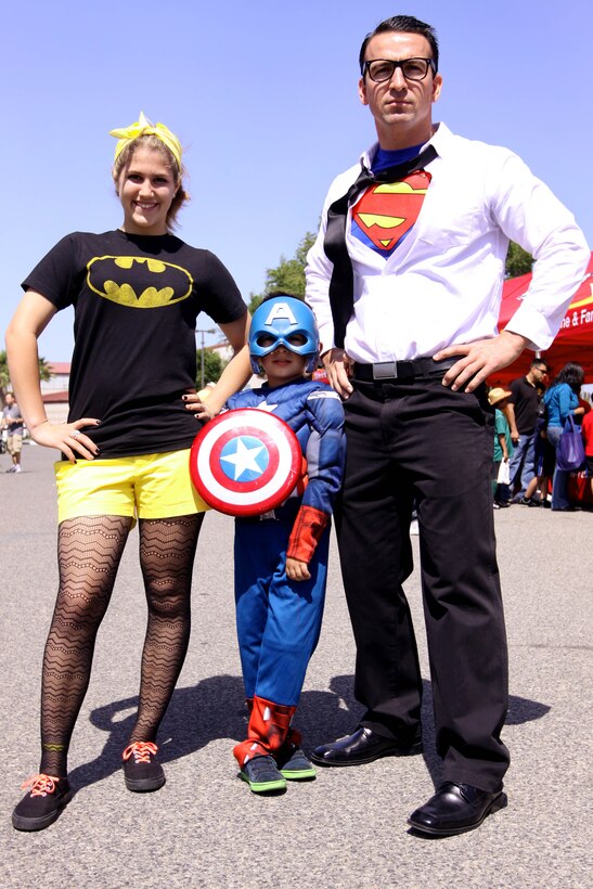 Hannah Liesik, left, 6-year-old Malakhi, center, and Dan Liesik dressed as Batgirl, Captain America and Superman during the 18th annual Kids First Fair hosted by Marine and Family Programs at the Paige Fieldhouse here April 27. The theme for this year’s event was “Kids are superheroes” and provided live attractions, demonstrations and entertainment including a pony rides, face painting and rock climbing for military youth. 
