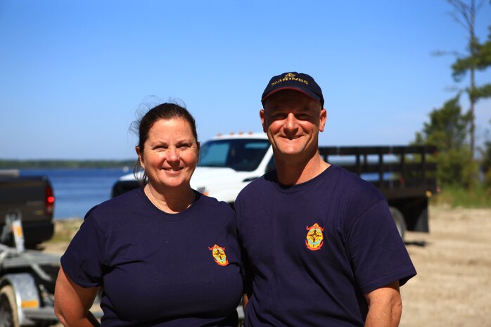 Alicia Filzen (left) and Master Sgt. Mark Rapoport (right) pose for a picture aboard Camp Lejeune, N.C., April 26, 2013. Filzen and Rapoport were in charge of the Splash for Trash event and said that events like it help bring people together and increase environmental awareness. (U.S. Marine Corps photo by Lance Cpl. Shawn Valosin)