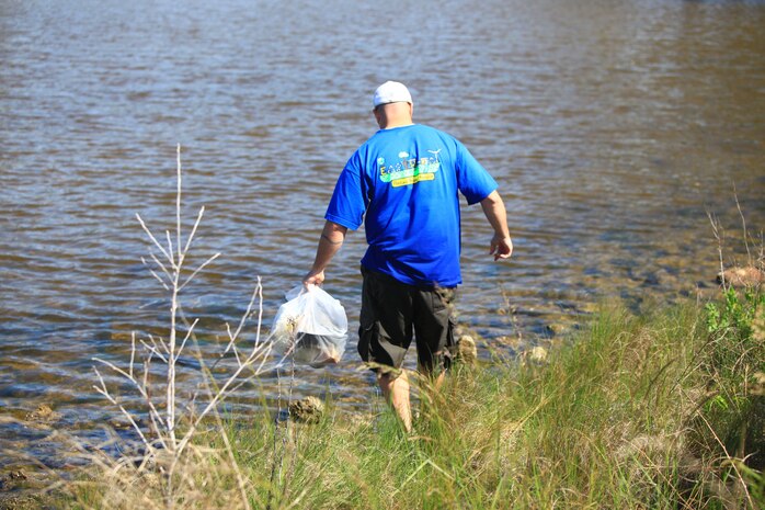 Gunnery Sgt. Ethan J. Mahoney, an Environmental Compliance Coordinator with 2nd Marine Logistics Group, picked up washed up debris around Camp Lejeune’s coastline during the Splash for Trash event April 26, 2013. Mahoney also started a pilot recycling program for the 2nd Marine Logistics Group. (U.S. Marine Corps photo by Lance Cpl. Shawn Valosin)