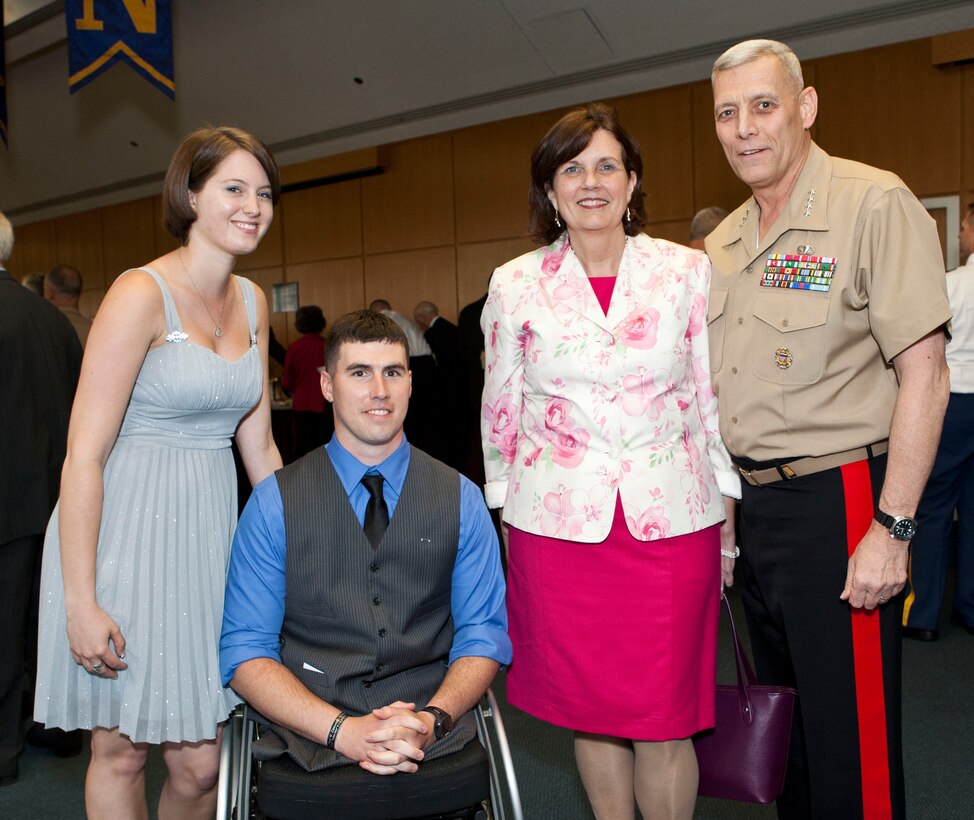From left, Kayla Dubois; Kevin Dubois, a Marine that was injured while deployed to Helmand Province, Afghanistan; Debbie Paxton and the Assistant Commandant of the Marine Corps, Gen. John M. Paxton, Jr., pose for a photo at the retirement ceremony reception in honor of Gen. John R. Allen, not shown, at the U.S. Naval Academy, Annapolis, MD, April 29, 2013. Allen, former commander for the International Security Assistance Force (ISAF), retired after serving over 30 years of service in the U.S. Marine Corps. (U.S. Marine Corps photo by Cpl. Tia Dufour/Released)