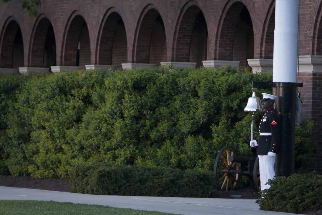 Lance Cpl. Timothy T. Baldwin, a time orderly with Marine Barracks Washington, D.C., sounds the bell prior to the commencement of a Friday Evening Parade at the Barracks April 26. 