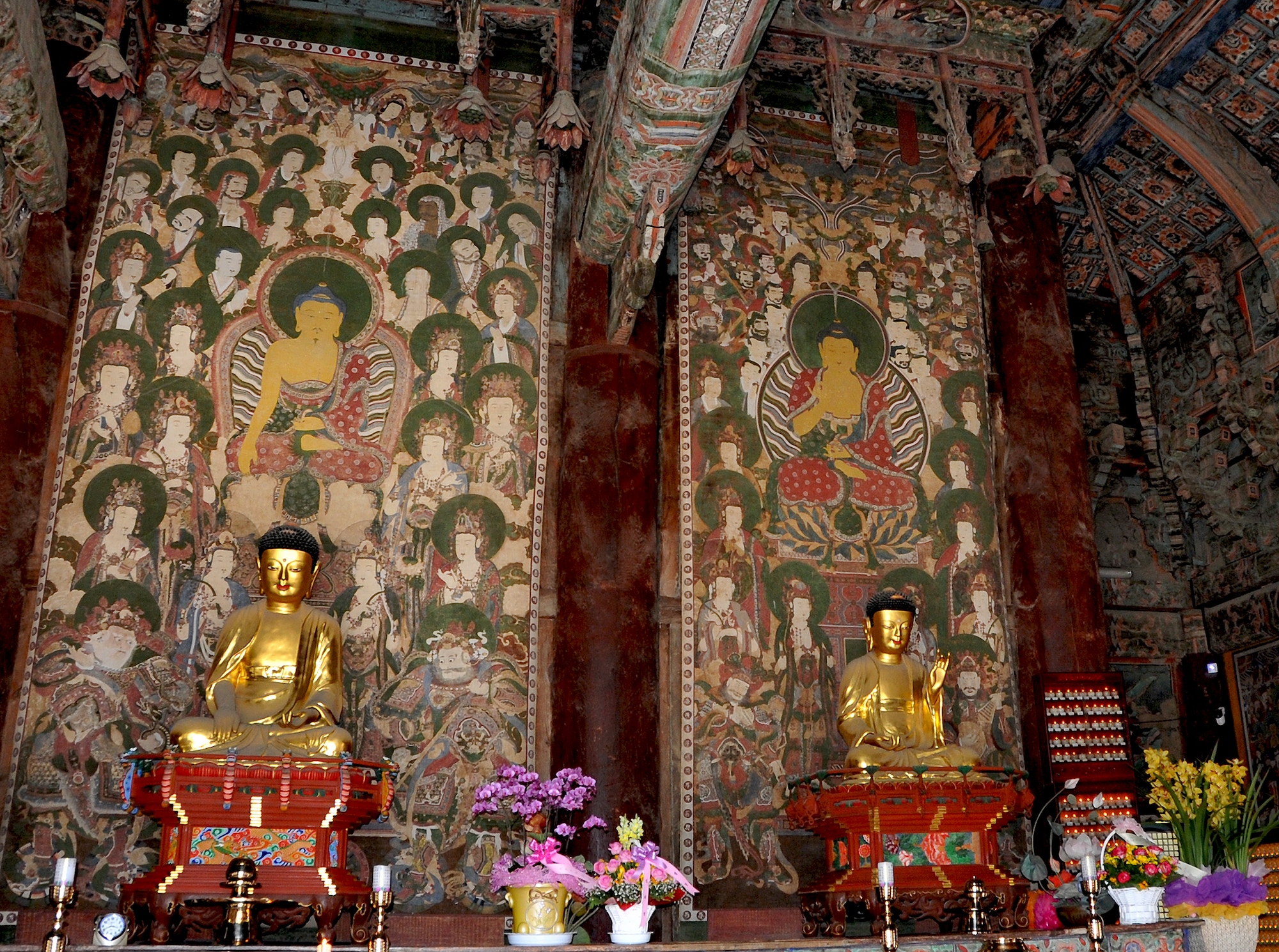 The Sakyamuni Buddha and the Yaksayeoraebul, the medicine Buddha, are two of the three focal alters in the Daeungjeon, the main Buddha hall of the Hwangaksan Jikjisa Temple, a highlight during the Information, Tickets and Travel trip April 27, 2013. The three Buddhist paintings, or Tenghwa, are referred to as Samjonbultaenghwa. Tenghwa is buddhistic paintings on either fabric or paper in order to be framed. On each painting, there are Bodhisattvas, celestial kings and guardian gods, surrounding the Buddha for harmony. The paintings were canvased on silk, and were created in 1744. (U.S. Air Force photo/Senior Airman Kristina Overton)