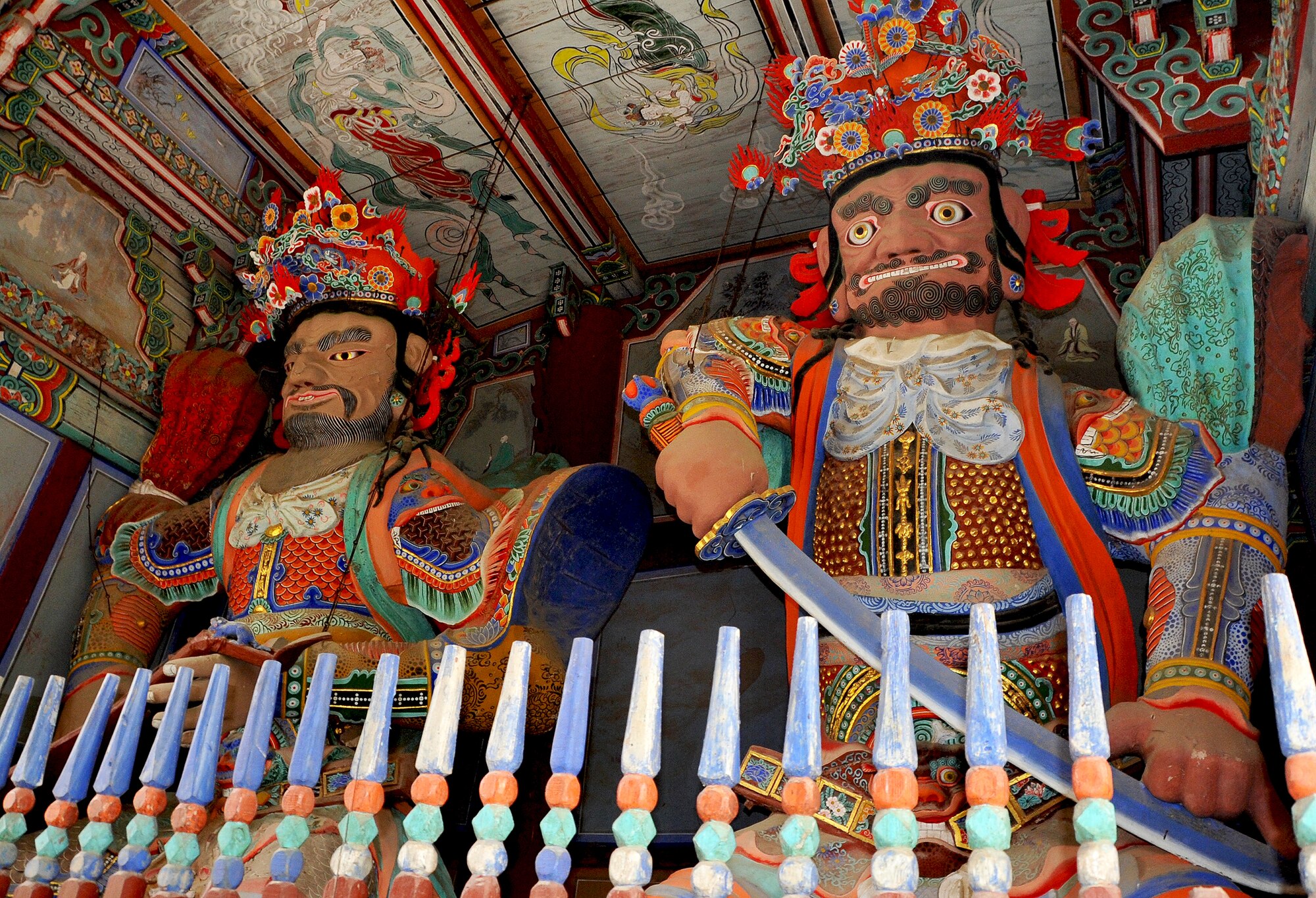 Two statues stand guard in the Cheonwangmun at the Hwangaksan Jikjisa Temple during an Information, Tickets and Travel trip April 27, 2013. There are four guardians made of clay in the hall, and they are said to protect the three jewels of the temple; the Buddha, the Dharma and the Sangha. (U.S. Air Force photo/Senior Airman Kristina Overton)