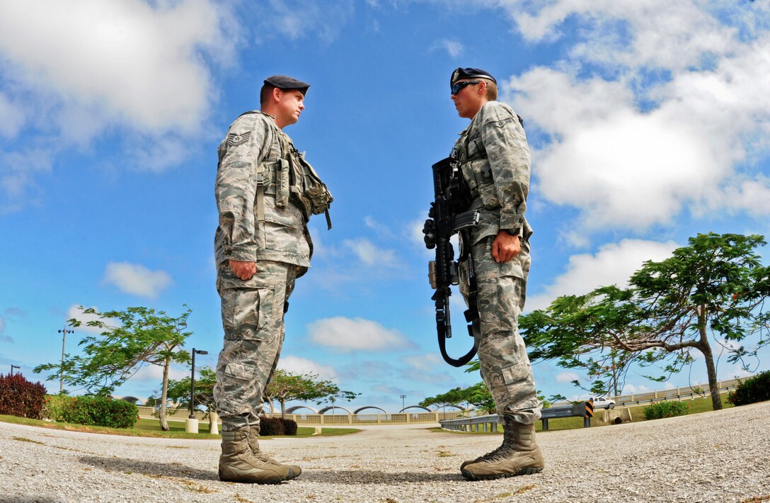 Airman 1st Class Sawyer Fox (right), 36th Security Forces Squadron Law Enforcement and Security alpha flight patrol member, reports to Tech. Sgt. Justin Traylor, 36th SFS Law Enforcement and Security alpha flight sergeant, during a post visit on Andersen Air Force Base, Guam, April 24, 2013. A flight sergeant is charged with coordinating all security and law enforcement duties for their shift and is required to be on scene for all incidents. (U.S. Air Force photo by Airman 1st Class Marianique Santos/Released)