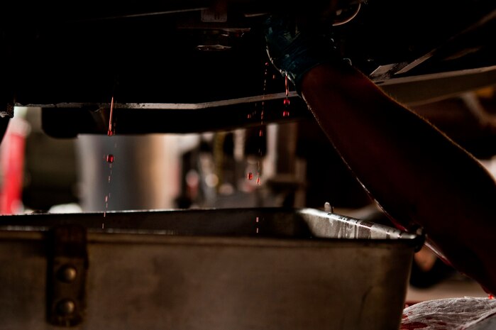 A Computer Science Corporation Aerospace Ground Equipment worker, fixes a hydraulic fluid leak on a munitions loader April 25, 2013, at Nellis Air Force Base, Nev. The hydraulic lines need to stay intact without leaks to ensure the equipment does not break. (U.S. Air Force photo by Senior Airman Daniel Hughes)