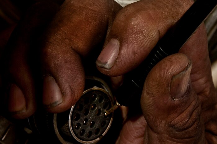 A Computer Science Corporation Aerospace Ground Equipment worker gauges the voltage on an electrical component of a generator April 25, 2013, at Nellis Air Force Base, Nev. The electrical wire was shorting out the generator, which is used to power aircraft before and after flights. (U.S. Air Force photo by Senior Airman Daniel Hughes)