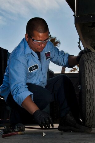 Jesse Paulino, Computer Science Corporation Aerospace Ground Equipment worker, checks the tire pressure on a self-generating nitrogen servicing cart April 25, 2013, at Nellis Air Force Base, Nev. The tire pressure check is the last step during a phase two inspection on a servicing cart which is conducted every two years. (U.S. Air Force photo by Senior Airman Daniel Hughes)