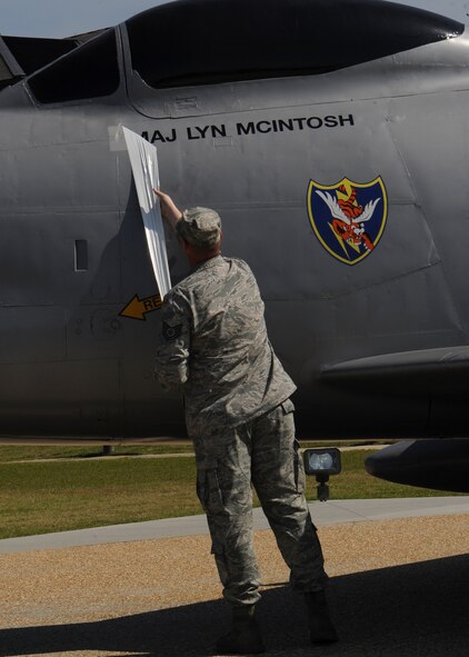 U.S. Air Force Tech. Sgt. John Holliday, 23d Equipment Maintenance Squadron aircraft structural maintenance craftsman, unveils Maj. Lyn McIntosh’s name on the F-86L Sabre memorial at Moody Air Force Base, Ga., April 27, 2013. The F-86 was transferred from Valdosta, Ga., to be refurbished and displayed at the President George W. Bush Air Park at Moody Field. (U.S. Air Force photo by Senior Airman Eileen Meier/Released)