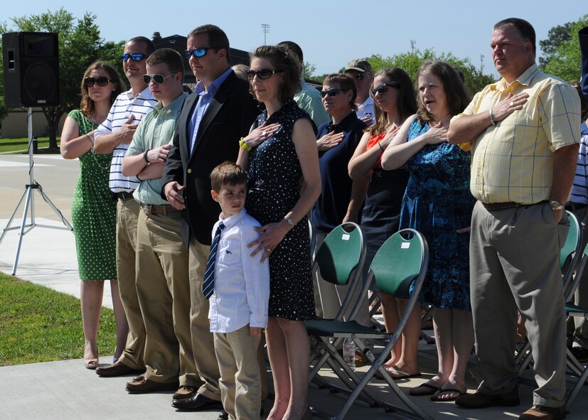 Family members of U.S. Air Force Maj. Lyn McIntosh, former rescue pilot  killed in 198 0 during Operation Eagle Claw , stand for the national anthem during the F-86L Sabre dedication ceremony at Moody Air Force Base, Ga., April 27, 2013. The F-86 was transferred from Valdosta, Ga., to Moody AFB April 25, 2012, to be refurbished and placed in the President George W. Bush Air Park at Moody Field. (U.S. Air Force photo by Senior Airman Eileen Meier/Released)