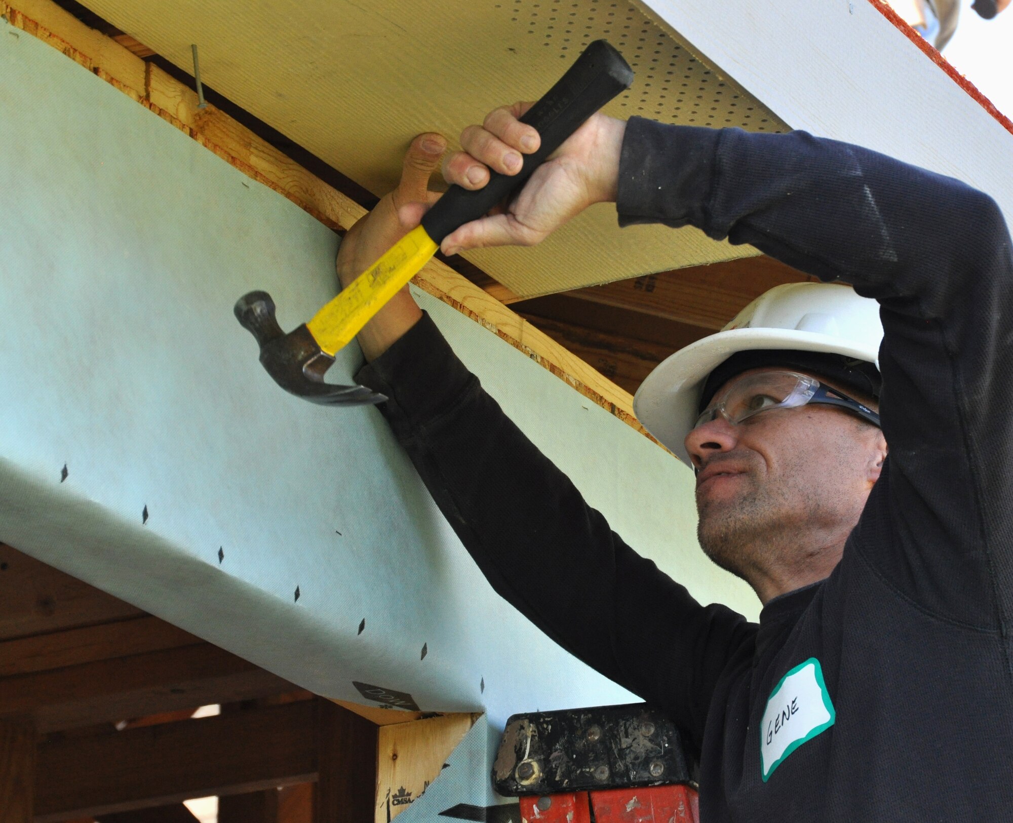 Master Sergeant Gene Gaspar, 301st Aircraft Maintenance Squadron weapons expediter, is nailing in the panels of the new home. The 301st AMXS members spent the day building a house for a local Fort Worth resident under the Habitat for Humanity program. (U.S. Air Force photo/Senior Airman Jeremy Roman)