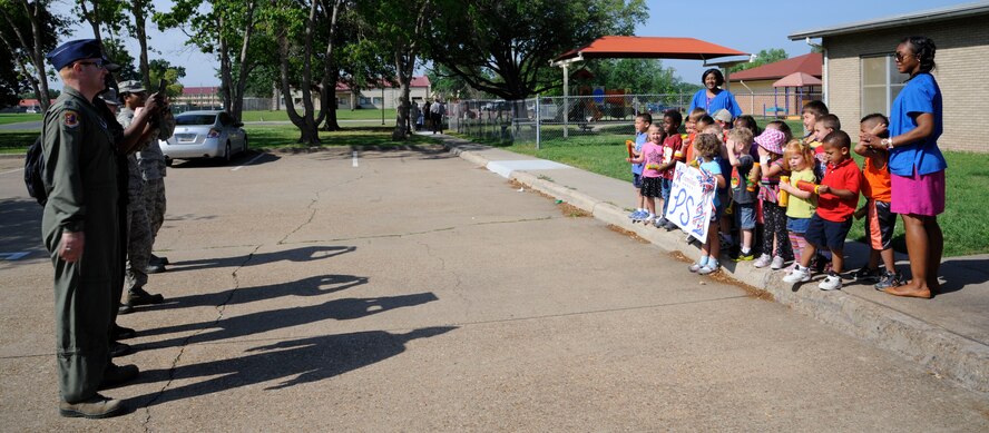 Parents take photos of their children and Child Development Center staff after the Month of the Military Child parade on Barksdale Air Force Base, La., April 30, 2013. The parade ended a month of celebrations of military children. (U.S. Air Force photo/Airman 1st Class Andrew Moua)
