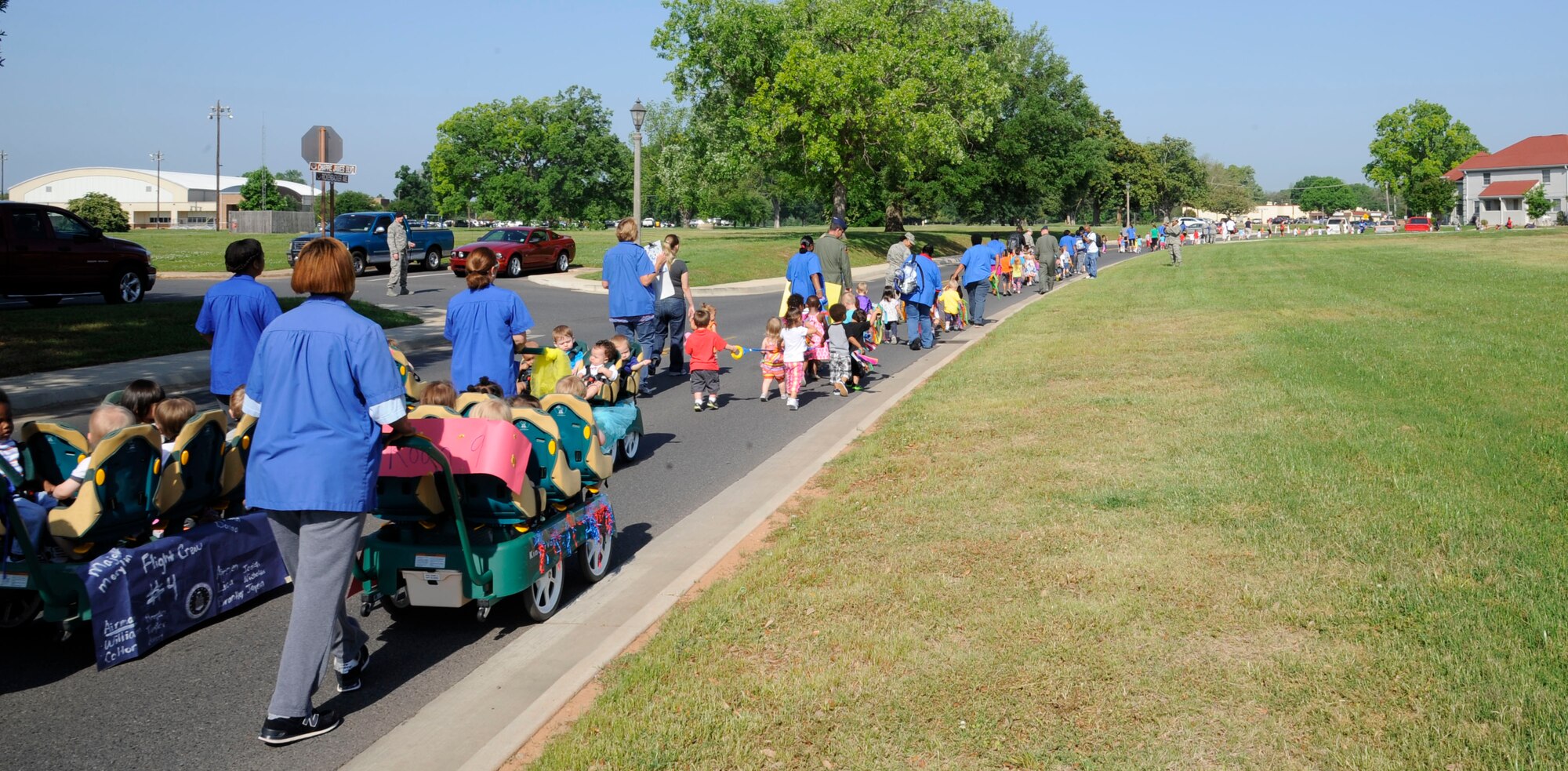 Parents, Child Development Center staff and children walk during the Month of the Military Child Parade on Barksdale Air Force Base, La., April 30, 2013. Each year during the month of April, the Child Development Center here holds various events to celebrate military children, such as tree planting, a trike-a-thon, an art auction, a parent breakfast and parade. (U.S. Air Force photo/Airman 1st Class Andrew Moua)