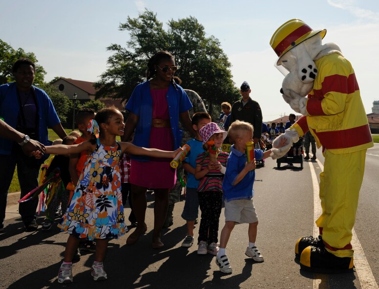 Children from the Child Development Center high-five Sparky during the Month of the Military Child Parade on Barksdale Air Force Base, La., April 30, 2013. The parade ended a month of celebrations of military children. (U.S. Air Force photo/Airman 1st Class Andrew Moua)