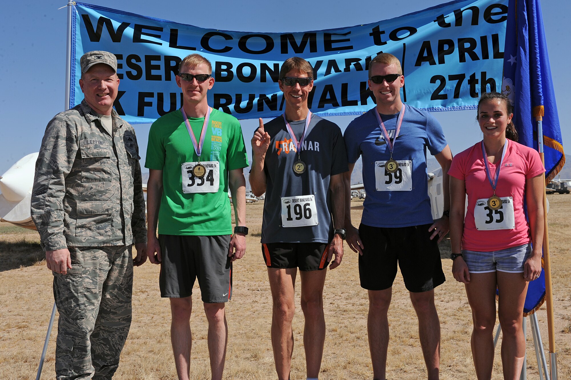 Desert Boneyard 5K Fun Run/Walk winners pose for a photo after completing the race at the 309th Aerospace Maintenance and Regeneration Group at Davis-Monthan Air Force Base, Ariz., April 27, 2013. Approximately 810 participants from around the local Tucson area registered for the 5K. (U.S. Air Force photo by Airman 1st Class Christine Griffiths/Released)