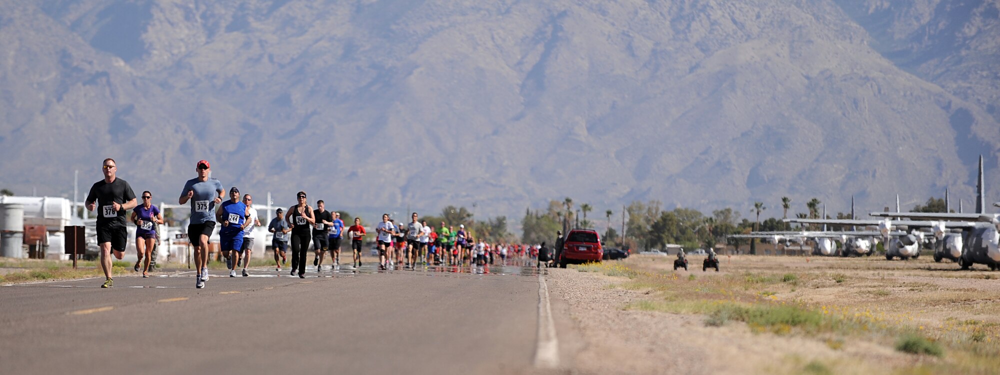 U.S. Active Duty Military and local Tucson residents race toward the finish line during the Desert Boneyard 5K Fun Run/Walk at the 309th Aerospace Maintenance and Regeneration Group at Davis-Monthan Air Force Base, Ariz., April 27, 2013. AMARG is looking to hold this event annually. (U.S. Air Force photo by Airman 1st Class Christine Griffiths/Released)