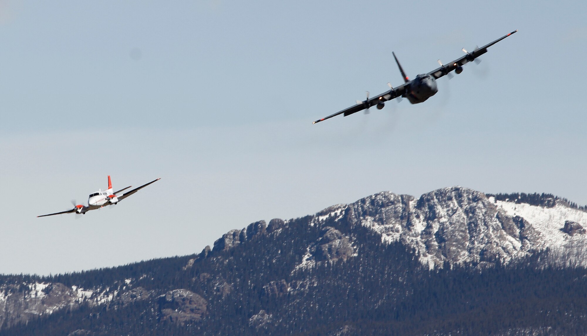 A Modular Airborne Fire Fighting System-equipped C-130 from the 302nd Airlift Wing follows a U.S. Forest Service lead plane to the drop site during annual MAFFS training April 21 in the Tarryall Mountains, Colo. The Air Force Reserve Command's 302nd AW held its MAFFS certification and recertification for C-130 aircrews April 19-23. (U.S. Air Force photo/Staff Sgt. Nathan Federico)