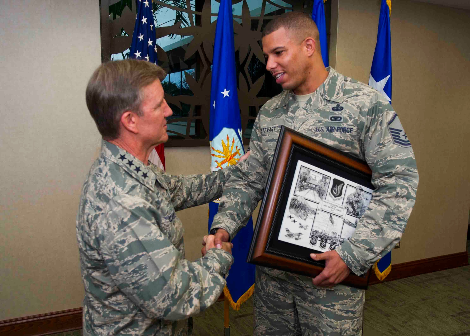 Gen. Hawk Carlisle, Pacific Air Forces commander, presents a plaque to Master Sgt. Tim Stewart, Network Control Center section lead, 374th Communications Squadron, Yokota Air Base, Japan, for his selection as one of PACAF’s twelve Outstanding Airmen of the Year April 22, 2013, at Joint Base Pearl Harbor-Hickam, Hawaii.  Stewart's selection distinguishes him from his peers by exceptional performance in the following areas: leadership and job performance in primary duty, significant self-improvement and base or community involvement. (U.S. Air Force photo/Staff Sgt. Nathan Allen)